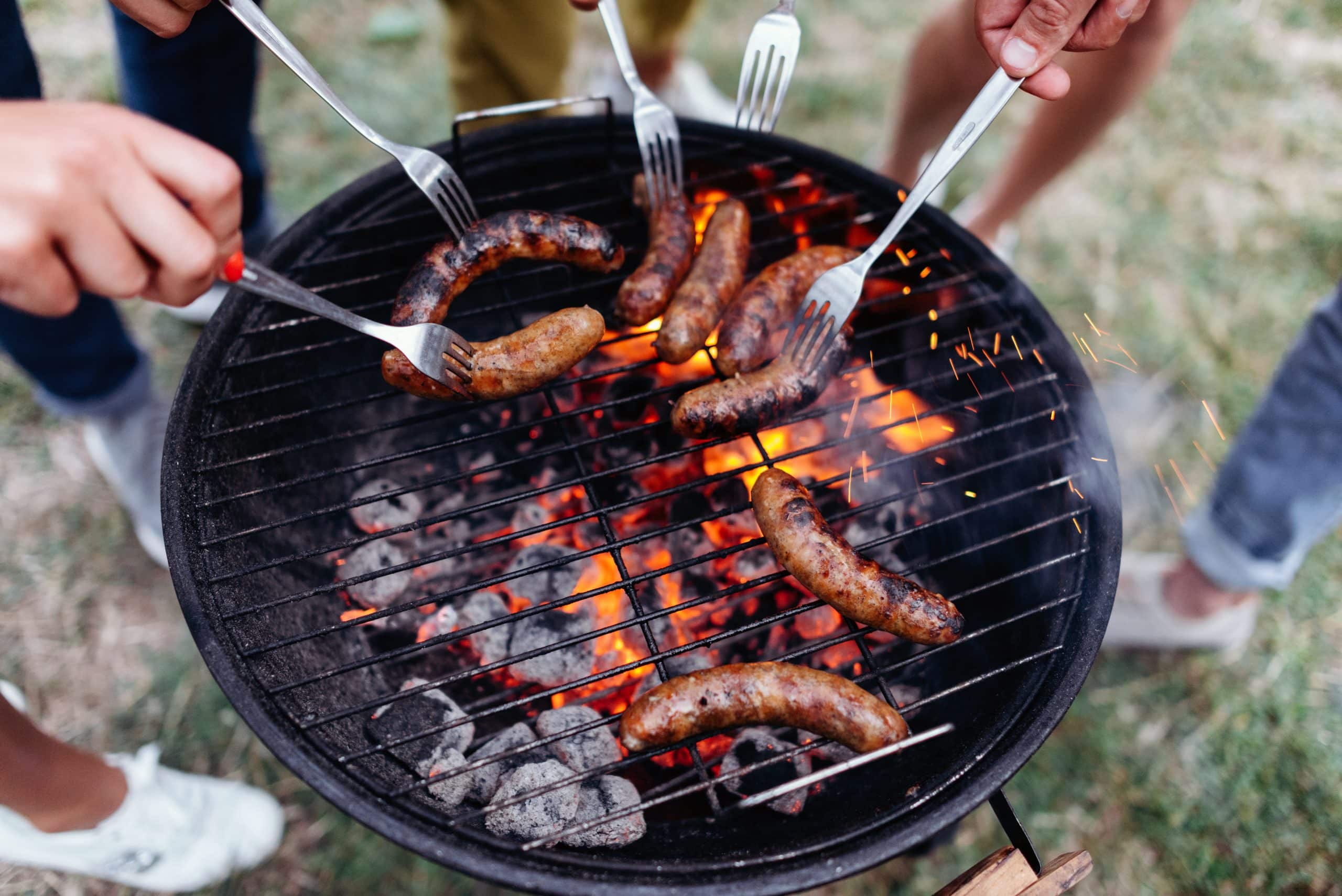 closeup a sausages cooking on barbecue