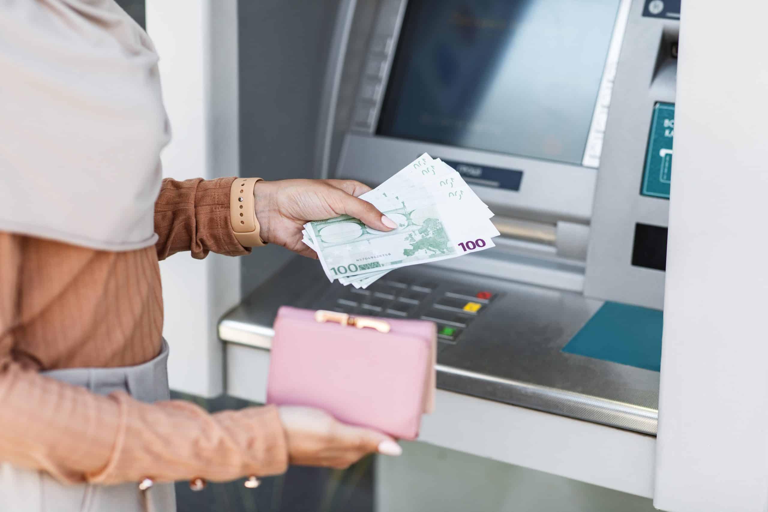 cropped young arab lady holds a lot of euros and a wallet