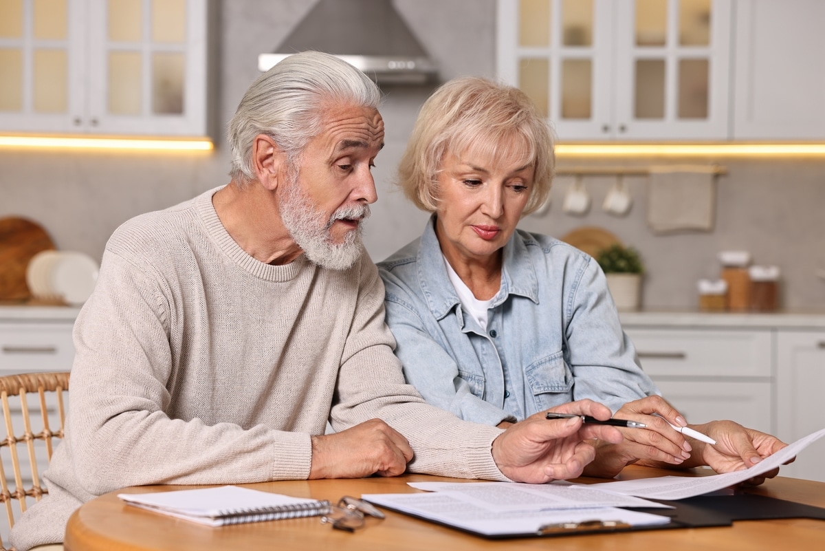 pension,savings.,senior,couple,planning,budget,at,wooden,table,indoors