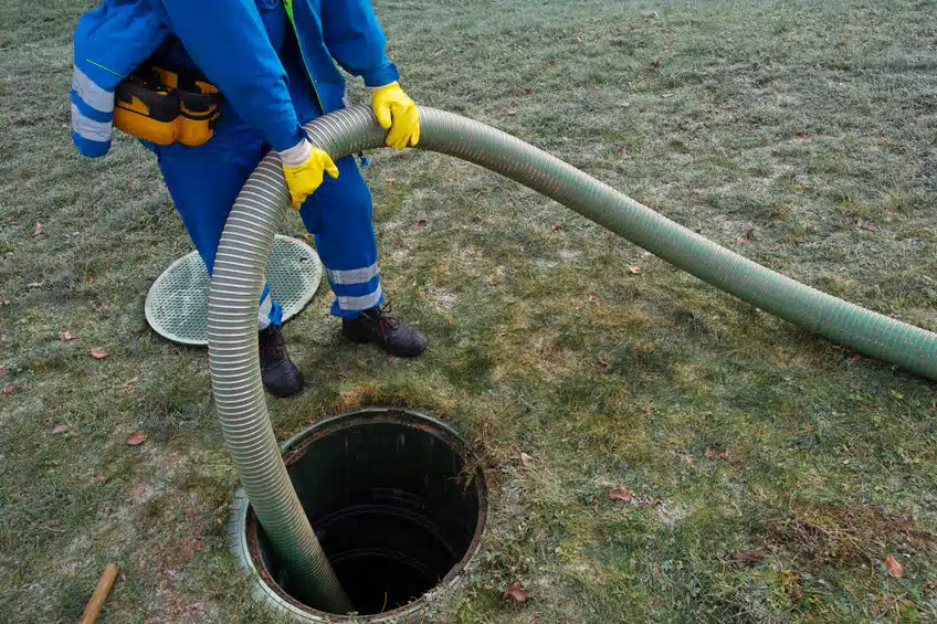 emptying household septic tank. cleaning sludge from septic system.