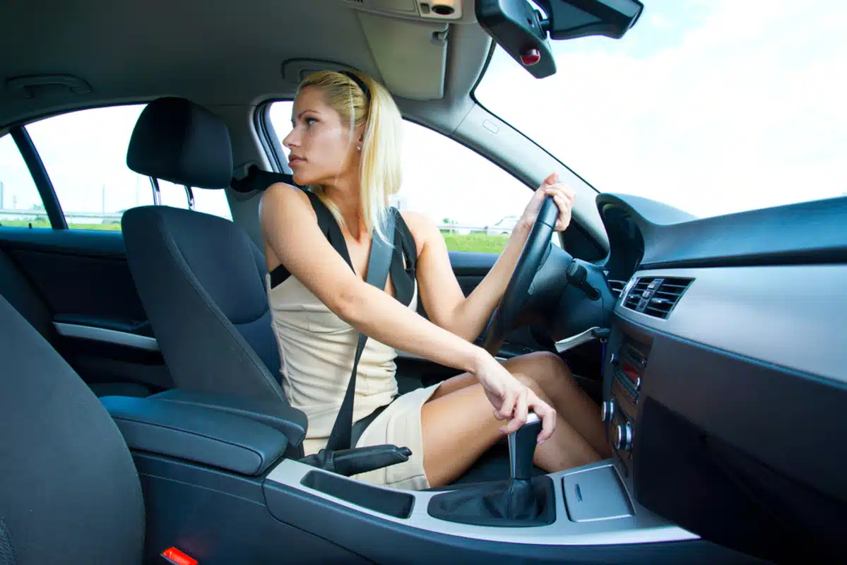 attractive,woman,driver,looking,back,and,parking,car